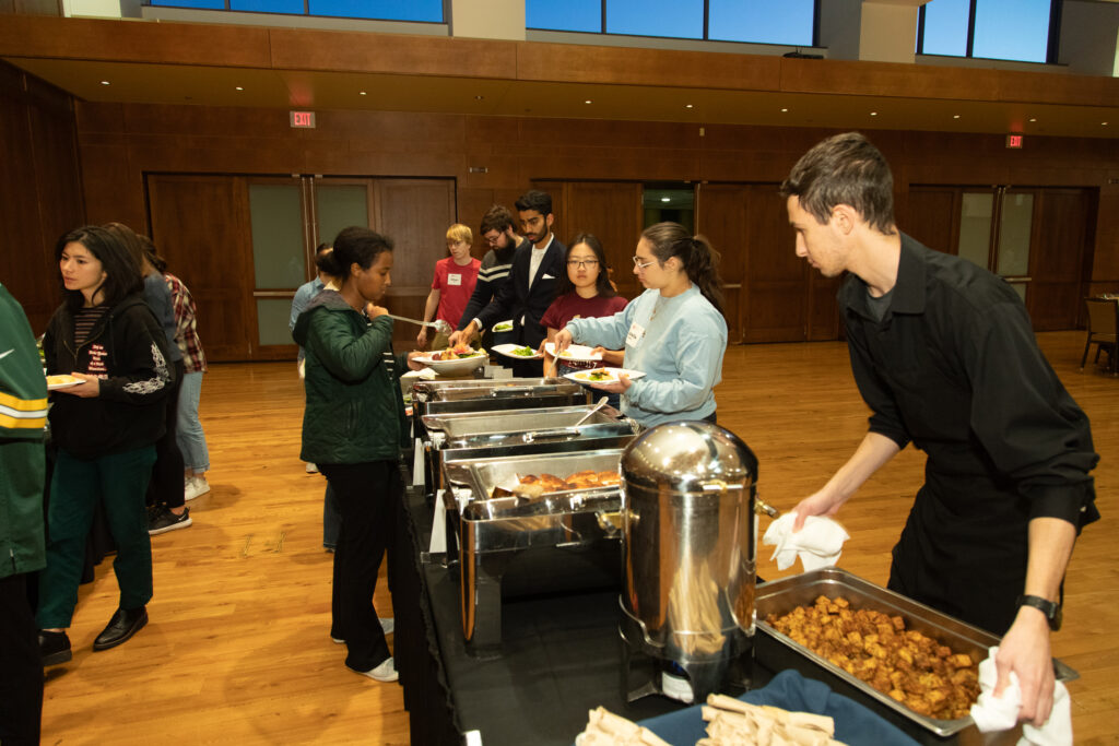 Students getting food at a buffet line