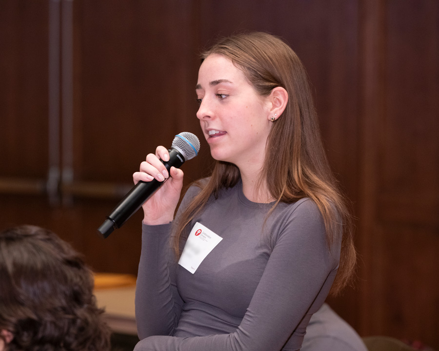 A student talking and holding a microphone